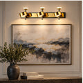 Illustrative scene: gold three-head wall light above artwork
