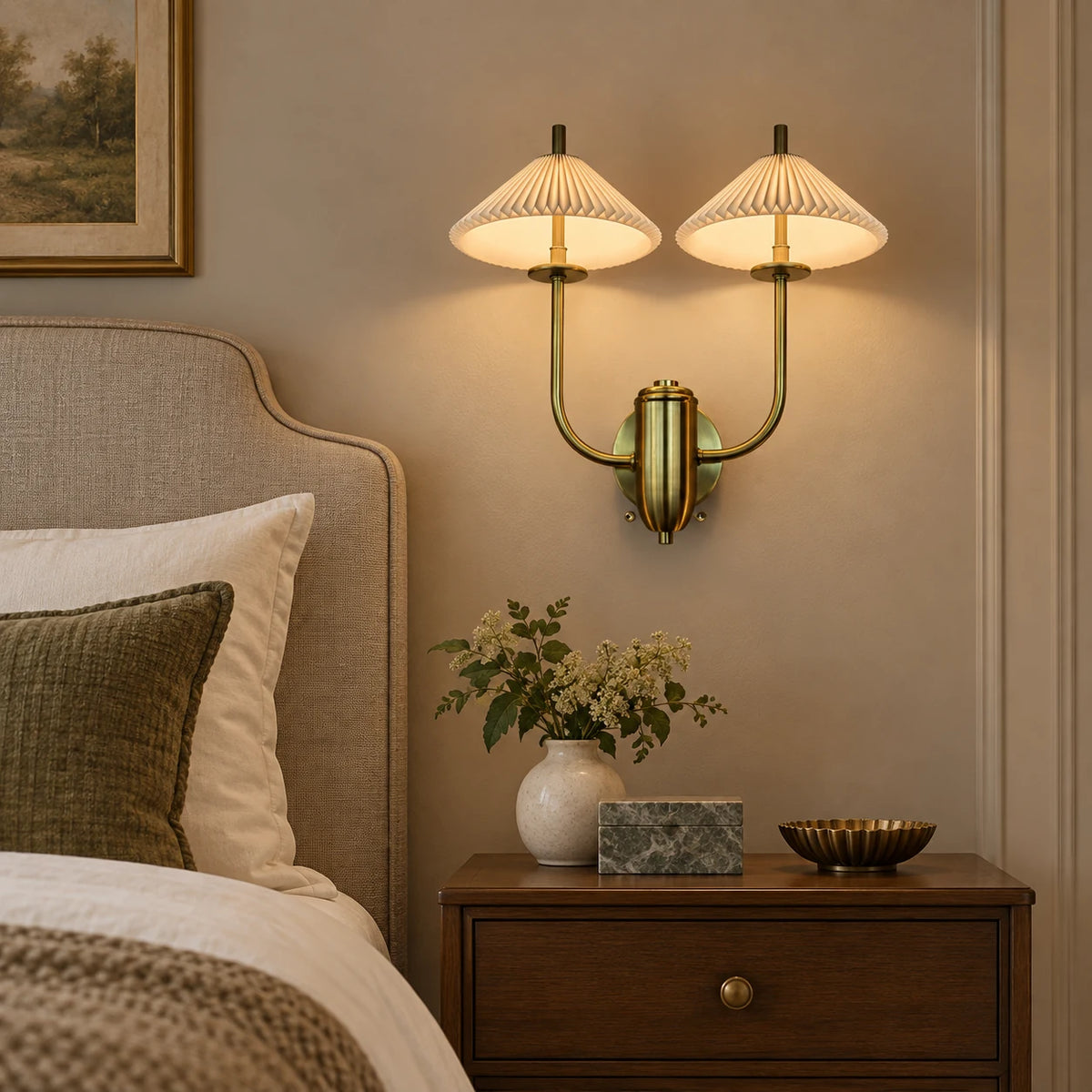 Twin pleated cone-shade wall sconce beside a bed