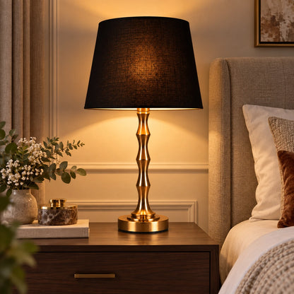 Black shade table lamp on a contemporary bedside table