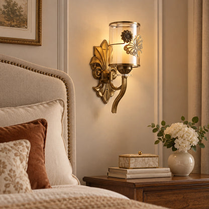Floral cylinder wall sconce beside a bed