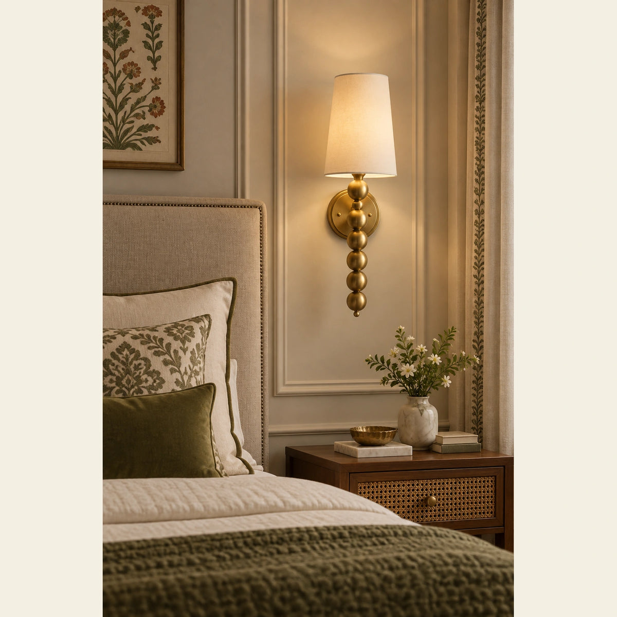 Beaded-stem shaded wall sconce beside a bedroom headboard