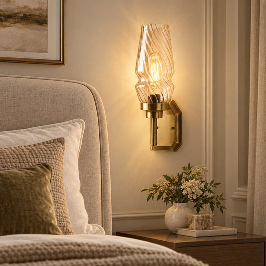 Sculpted ripple-shade wall sconce beside an upholstered bed