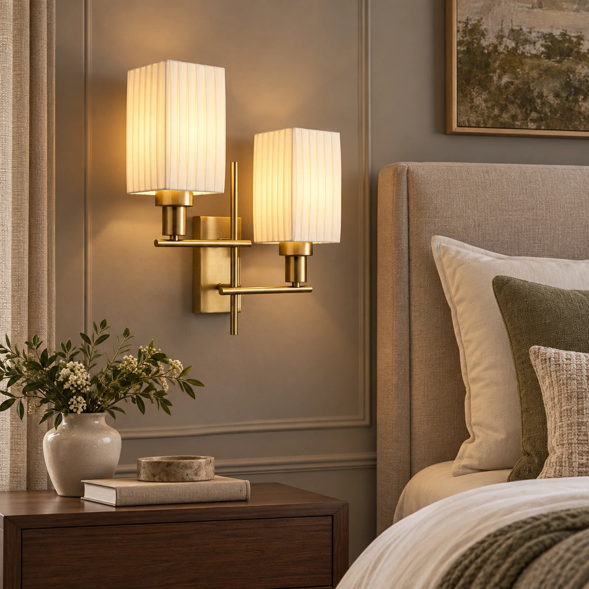 Twin pleated shade wall sconce beside a bed