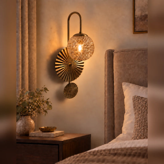 Textured globe fan wall light beside a bed