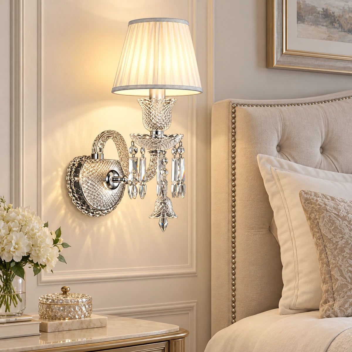 Crystal accent wall sconce beside an upholstered bed