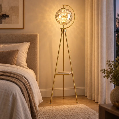Patterned-globe tripod floor lamp in a bedroom corner