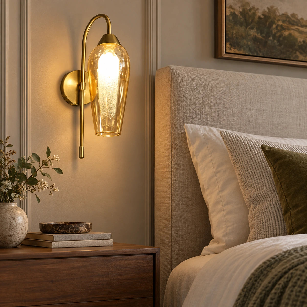 Amber capsule glass wall sconce beside a bed
