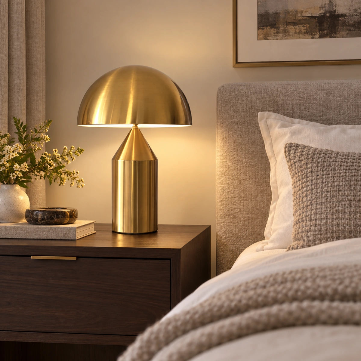 Antique-gold dome table lamp on a bedroom bedside table
