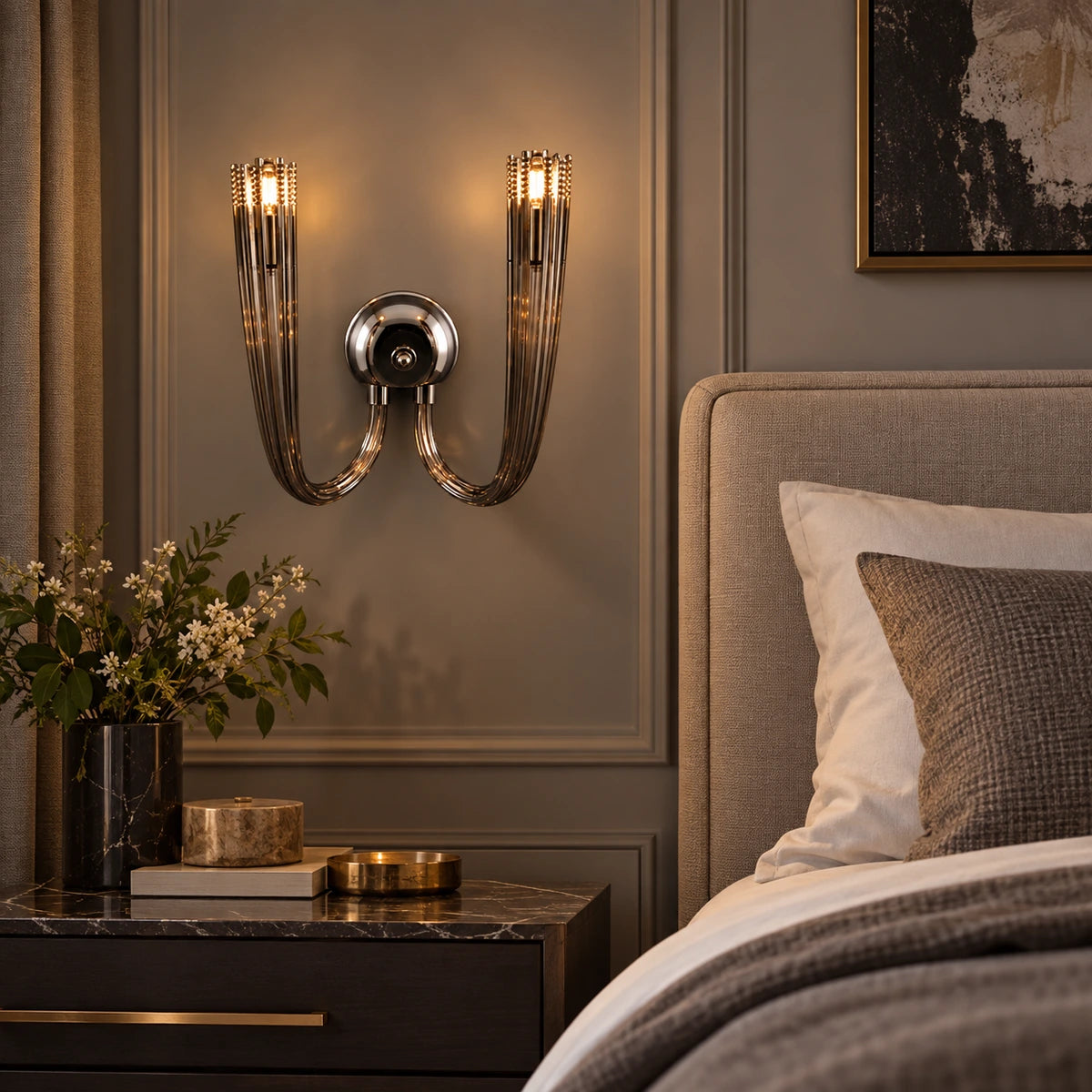 Twin-arm smoked-glass wall sconce beside a bed