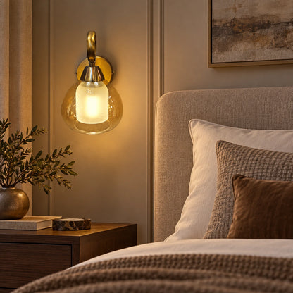 Amber nested-glass wall sconce beside a bed