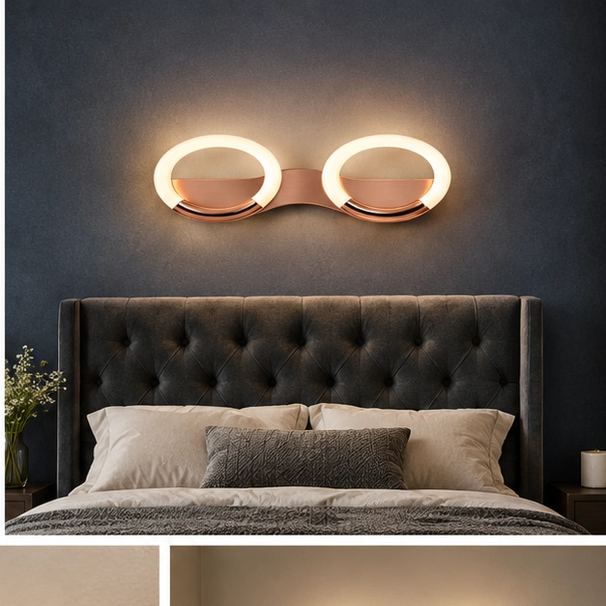 Rose-gold oval-ring wall light above a bed