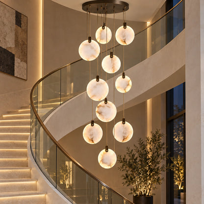 Ten-disc marble cascade chandelier beside a curved staircase