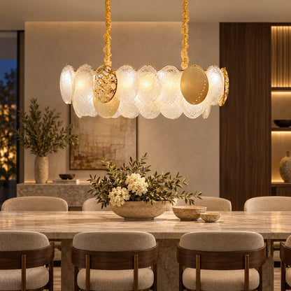 Frosted-disc linear pendant above a dining table