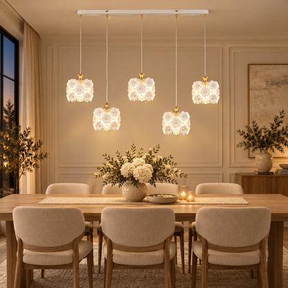 Floral ceramic five-shade pendant cluster above a dining table