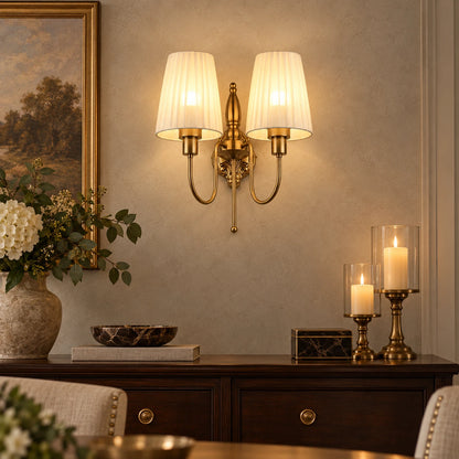 Twin pleated-shade wall sconce above a dining-room sideboard