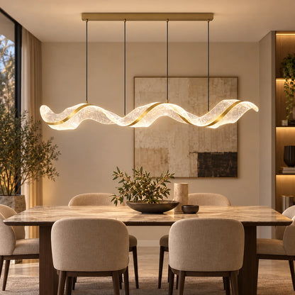 Sculptural wave LED chandelier above a dining table