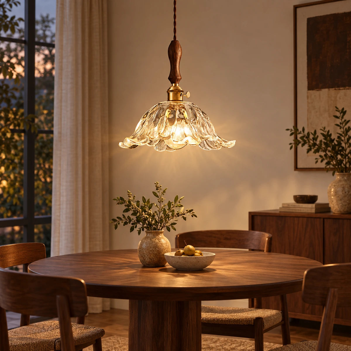 Carved glass bell pendant above a dining table