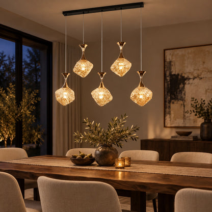 Five-light faceted glass cluster pendant above a dining table