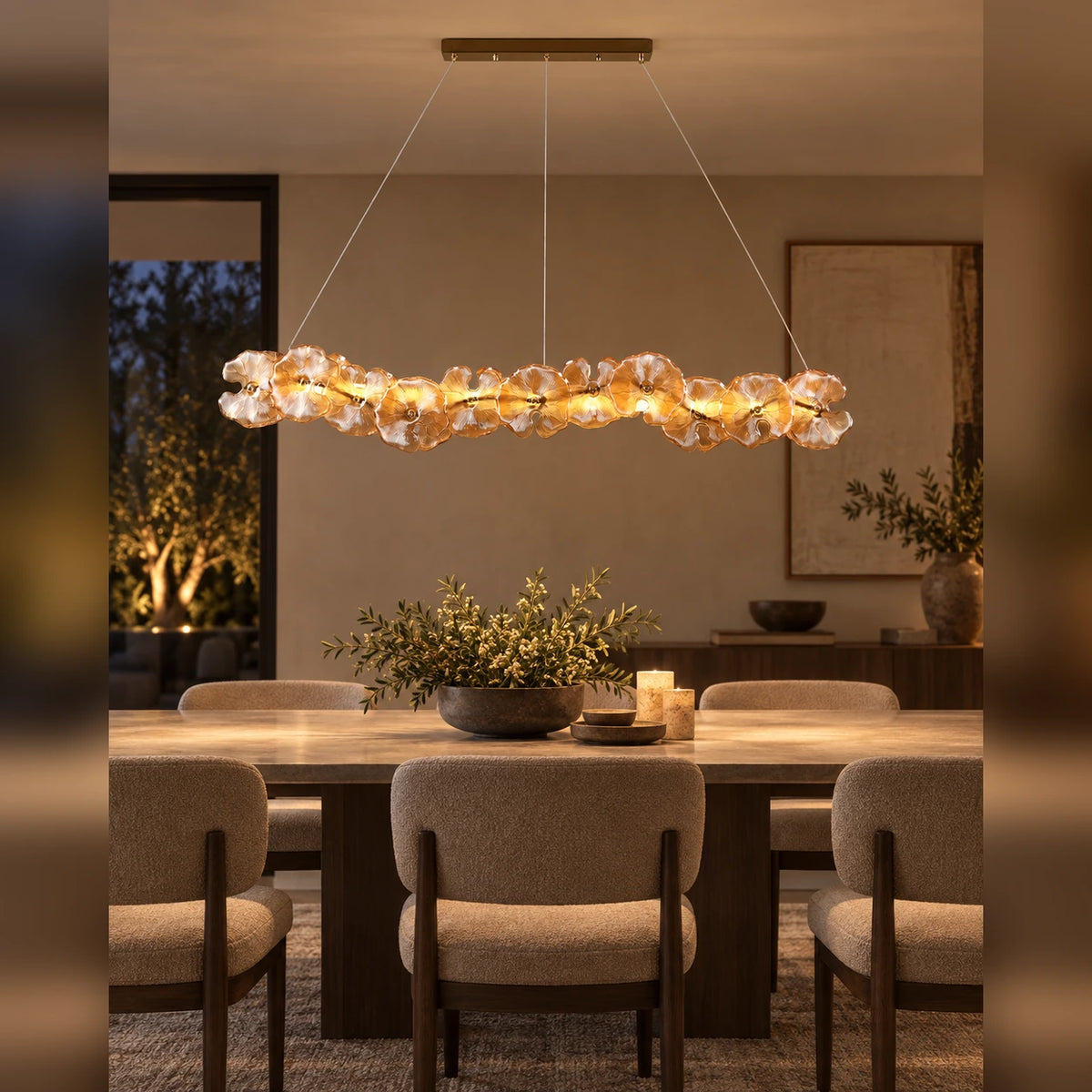 Floral glass linear pendant above a dining table