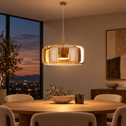 Amber glass capsule pendant above a dining table