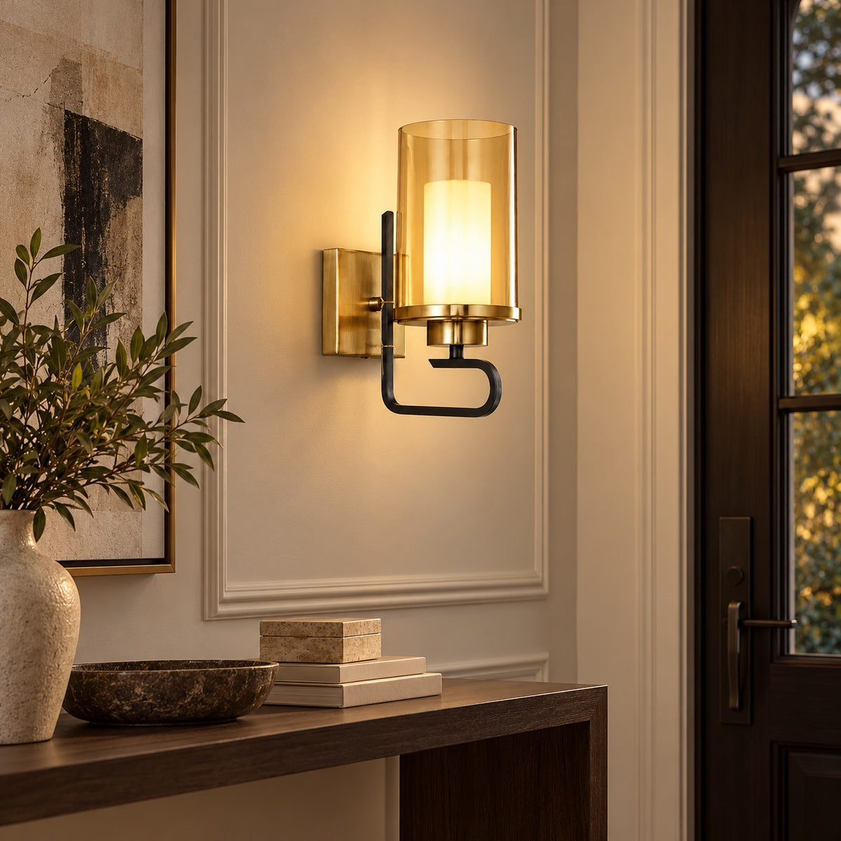 Aurelia amber-cylinder wall sconce illuminated in a refined entryway
