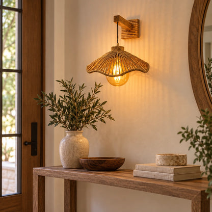 Woven bell shade wall sconce above an entryway console