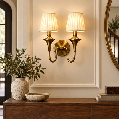Double arm tapered shade wall sconce in a warm entryway