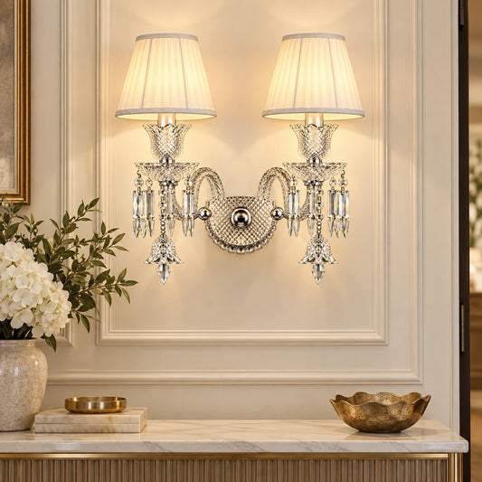 Double-shade crystal wall sconce above an entryway console