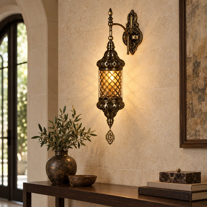 Antique mesh-globe wall sconce above an entryway console