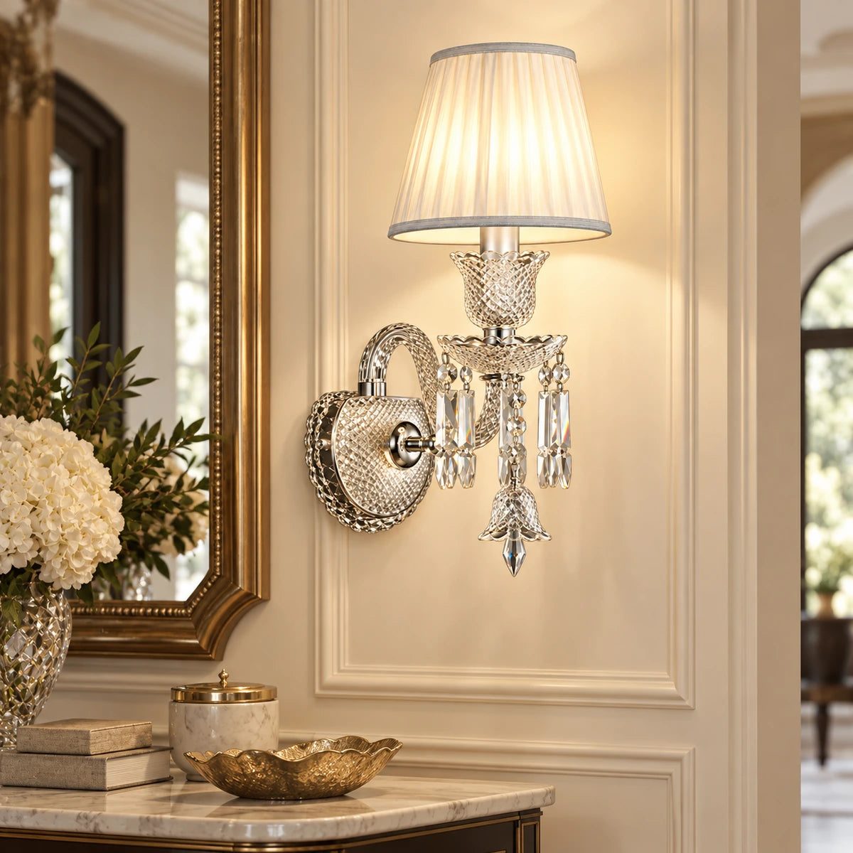 Crystal accent wall sconce beside an entryway console and mirror