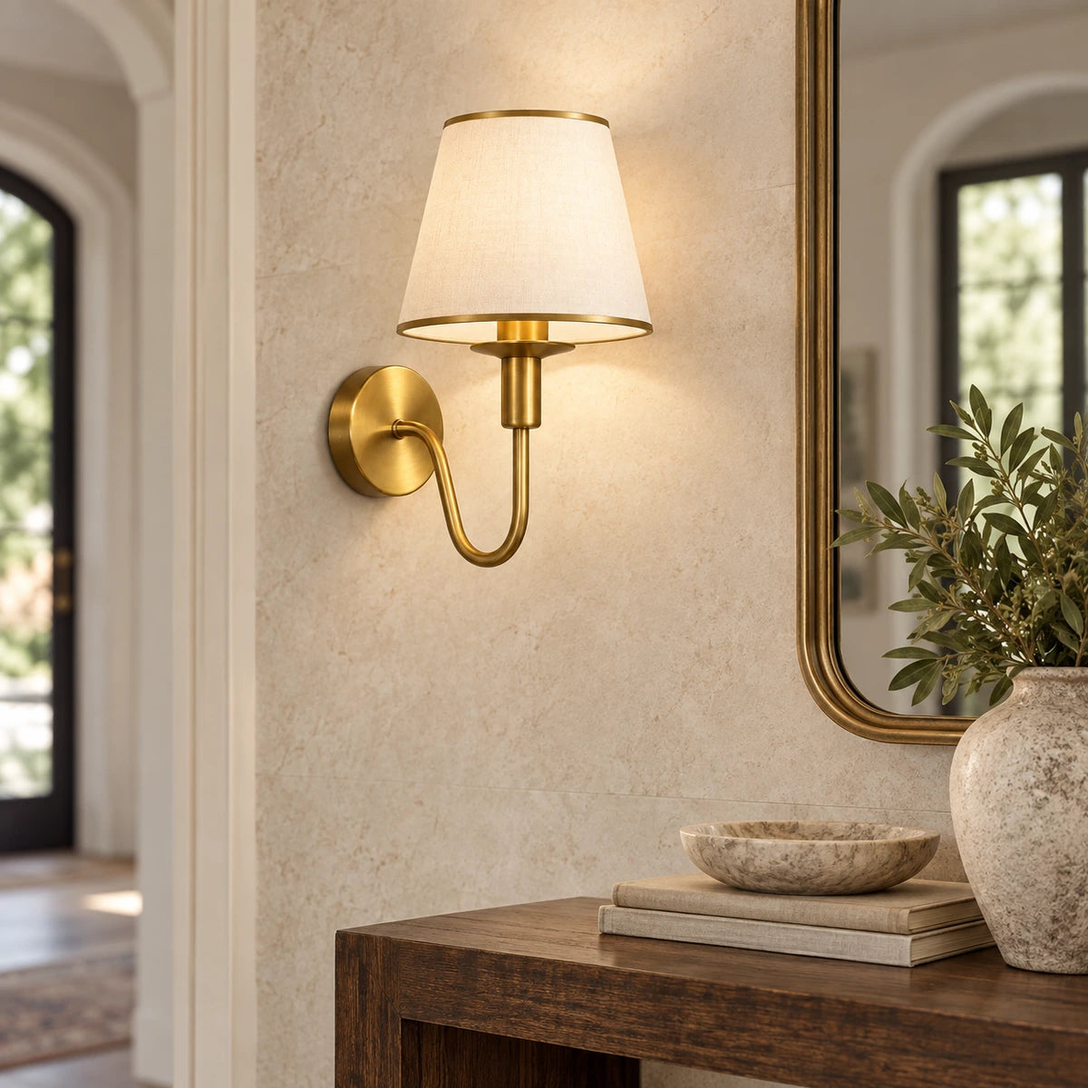 Curved arm shaded wall sconce in an entryway