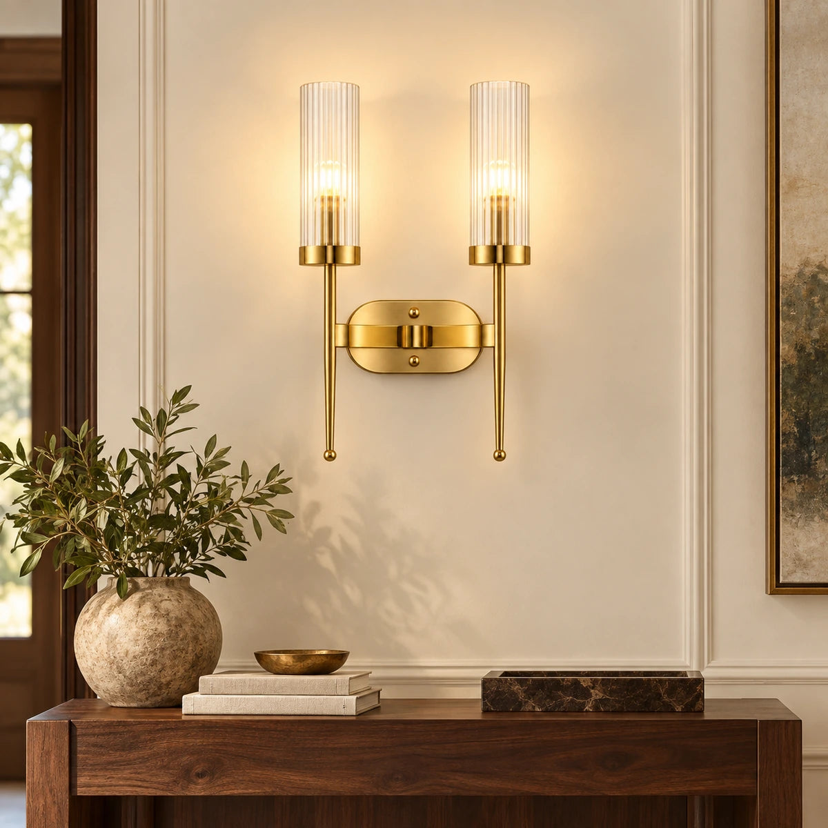 Twin ribbed glass cylinder wall sconce in a warm entryway