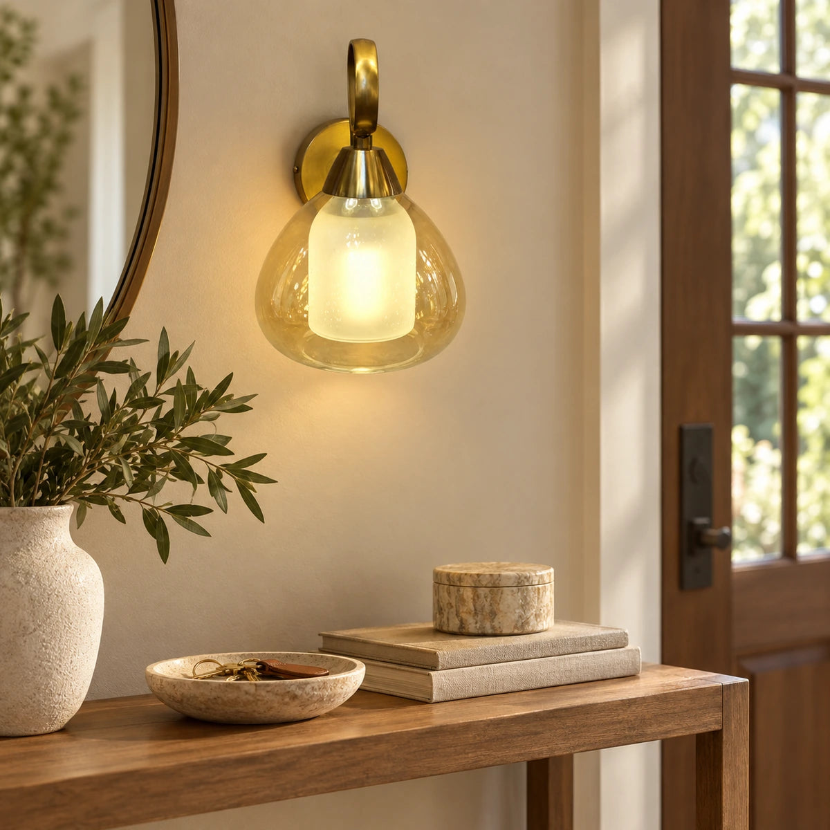 Amber nested-glass wall sconce above an entry console