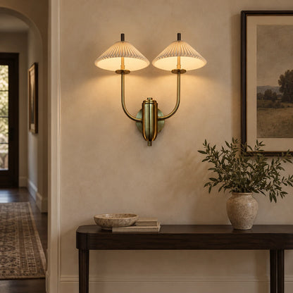 Twin pleated cone-shade wall sconce above a hallway console