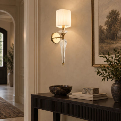Faceted clear-stem shade wall sconce above a hallway console