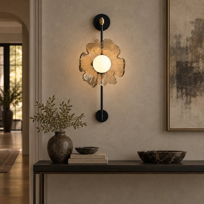 Textured petal globe wall sconce above a hallway console