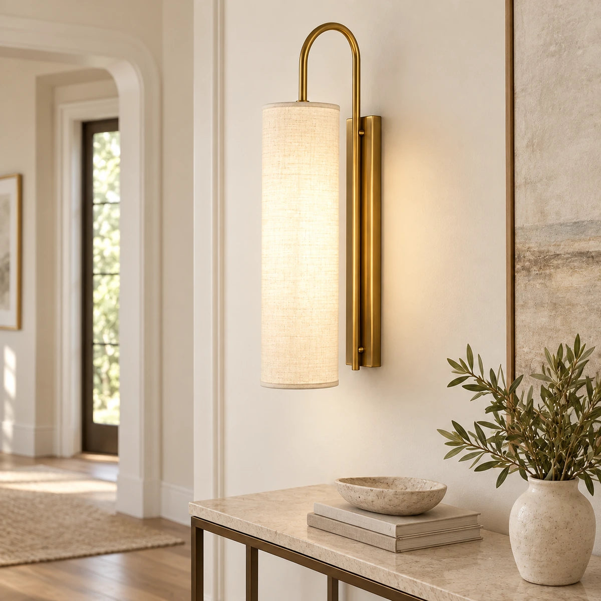 Tall cylinder shade wall sconce in an entryway