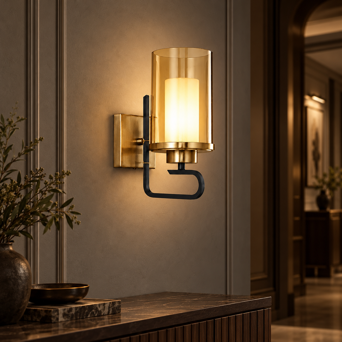 Aurelia amber-cylinder wall sconce illuminated in a moody boutique-hotel corridor