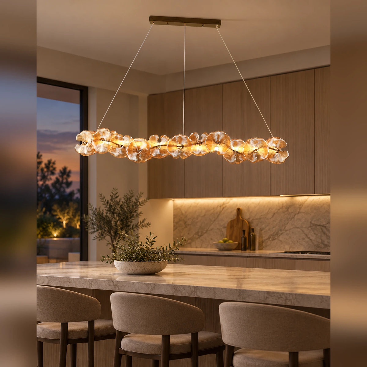 Floral glass linear pendant above a kitchen island