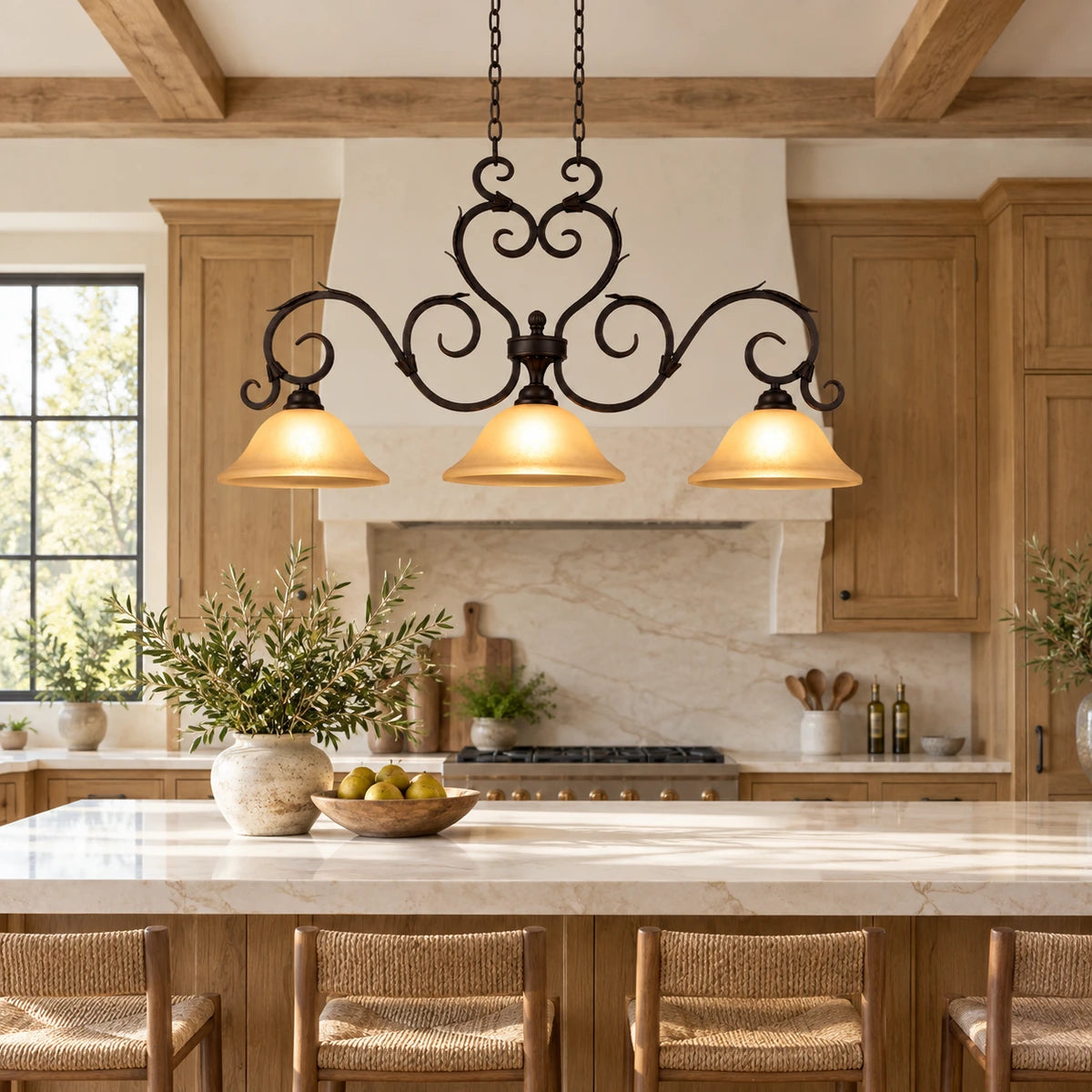 Antique-scroll three-shade linear pendant above a kitchen island