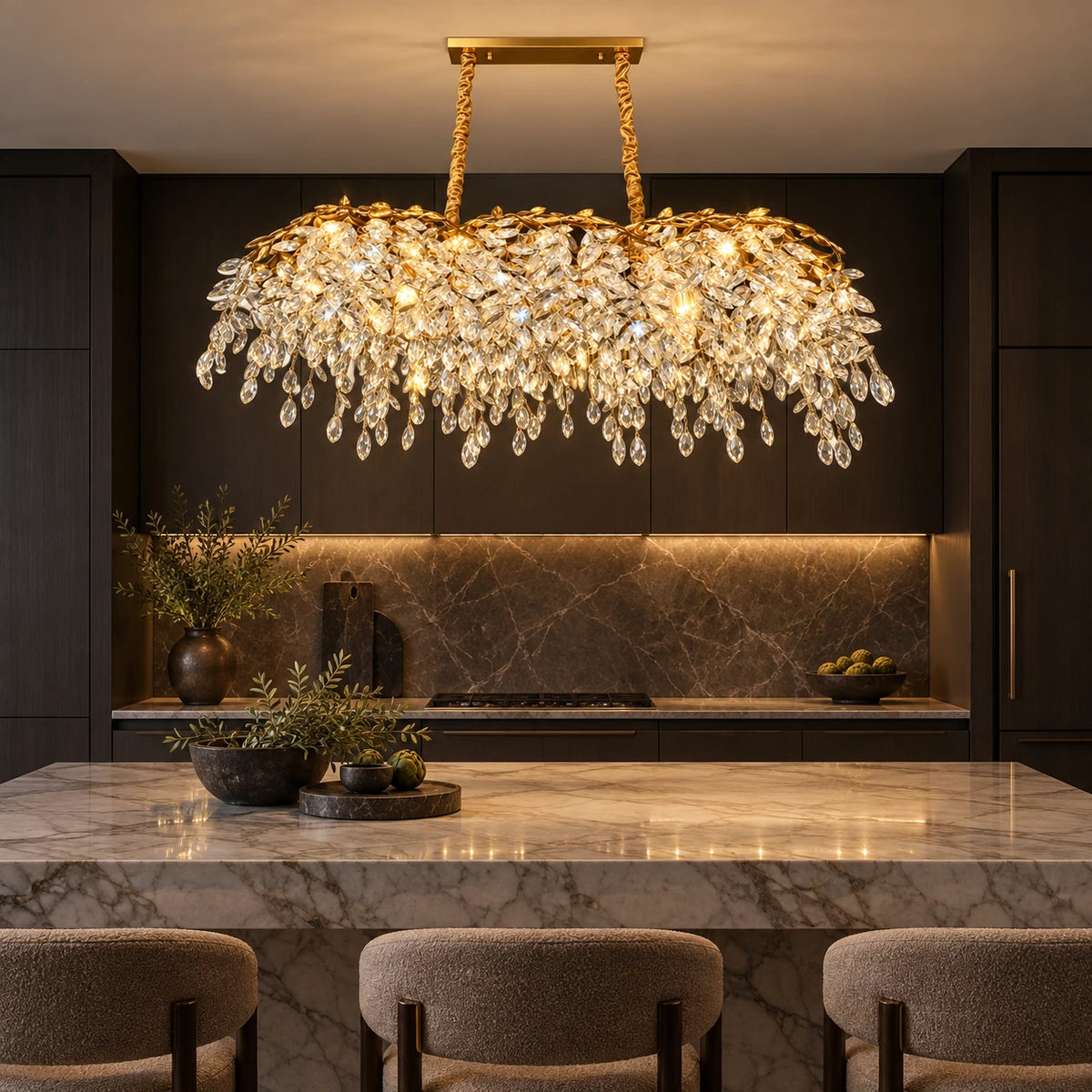 Linear crystal chandelier above a marble kitchen island
