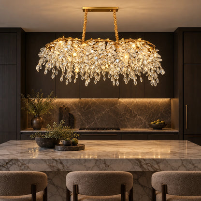 Linear crystal chandelier above a marble kitchen island