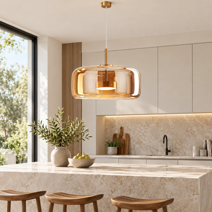 Amber glass capsule pendant above a kitchen island