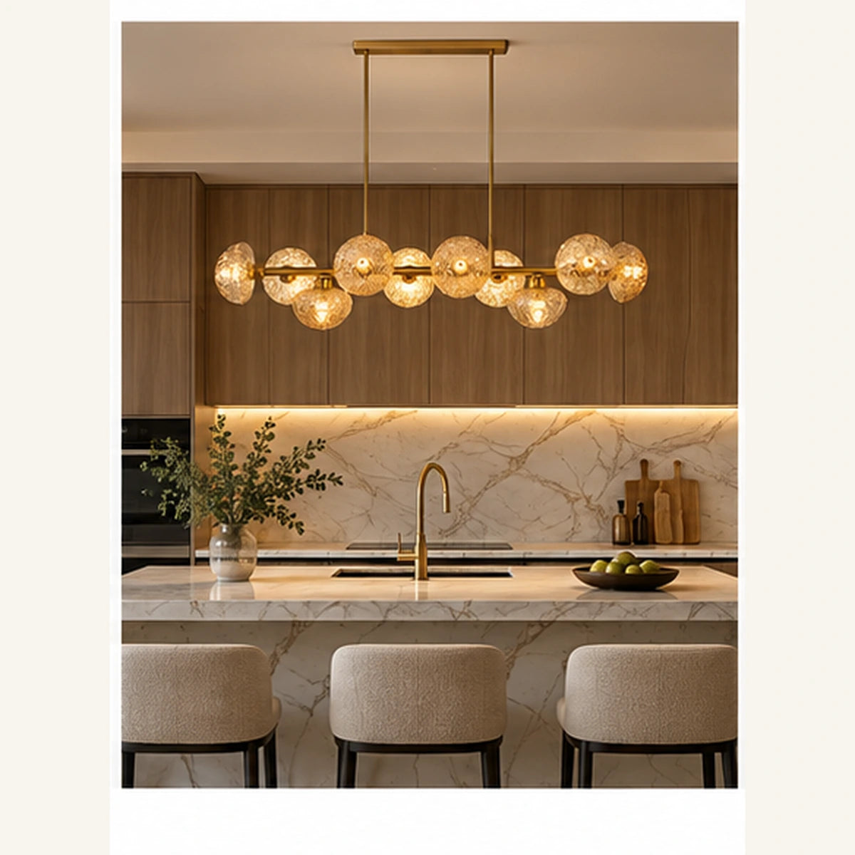 Gold amber globe chandelier above a kitchen island