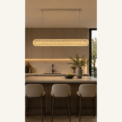 Clear acrylic linear pendant above a kitchen island