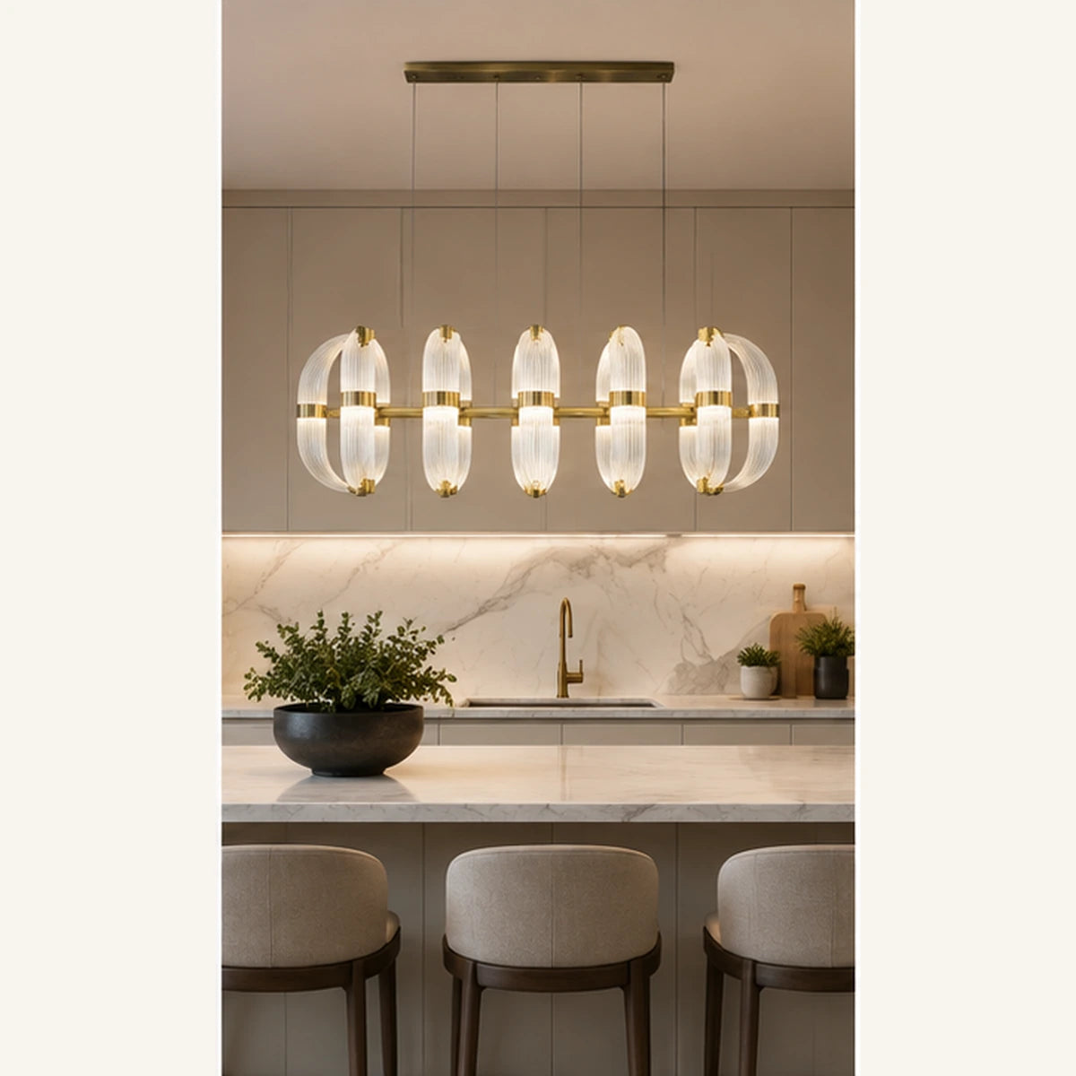 Ribbed glass linear chandelier above a kitchen island