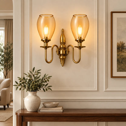 Twin amber tulip-shade wall sconce above a living-room console