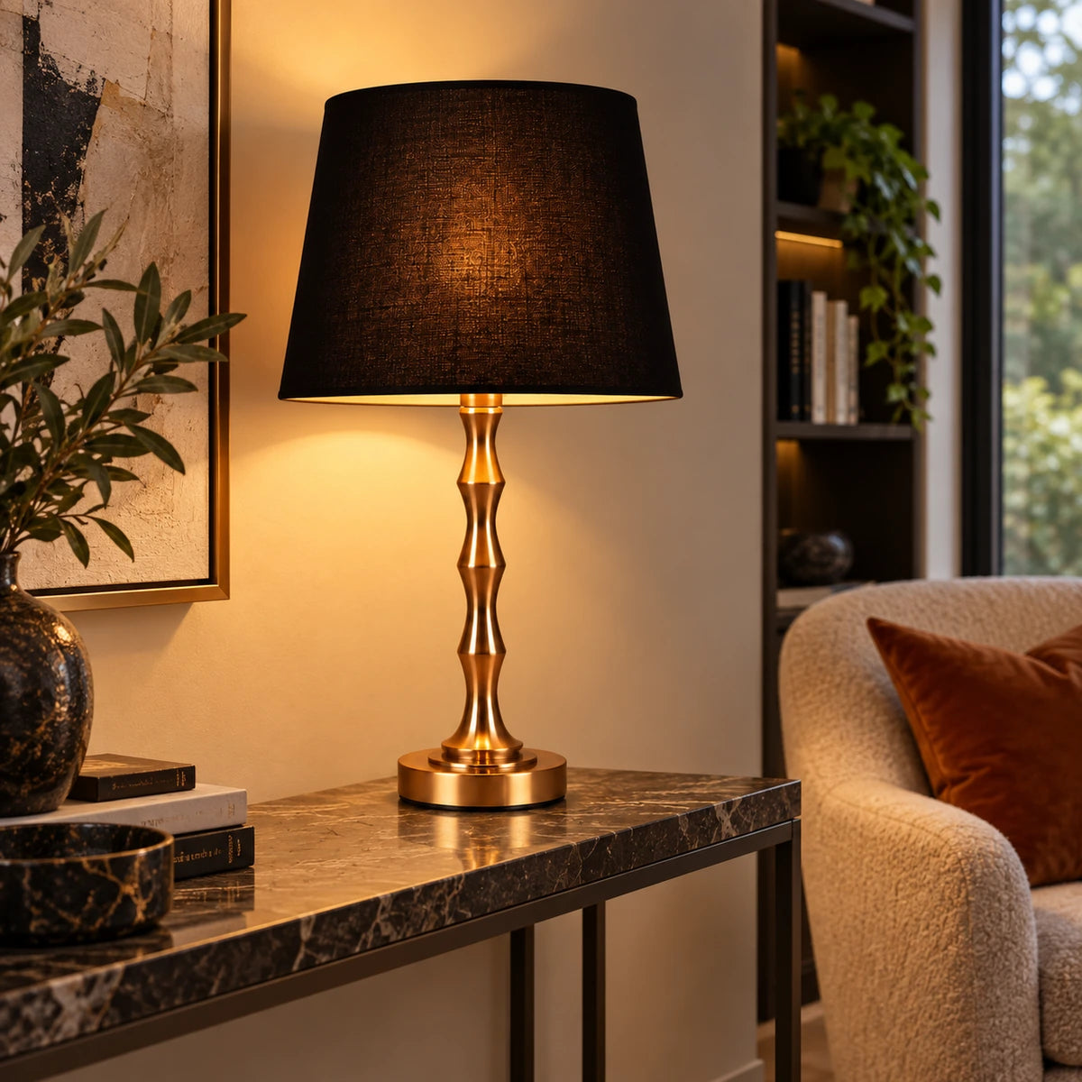 Copper-tone table lamp on a living room console