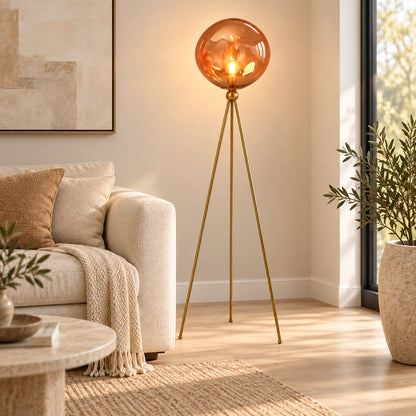 Amber-globe tripod floor lamp beside living room seating