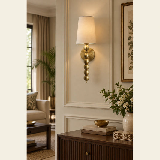 Beaded-stem shaded wall sconce in a living room